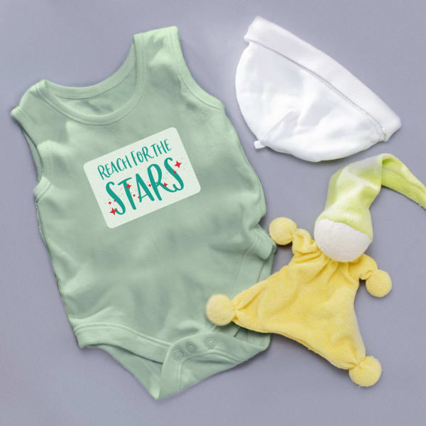 Image showing green snapsuit with an Avery baby onesie template that reads “reach for the stars.”