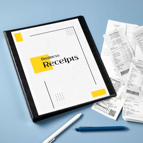 A black binder (Avery 79809) with a cover sheet that reads "Business Receipts," shown with a variety of receipts to be organized. 