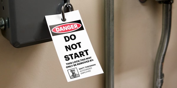 An example of a lockout tagout tag placed directly on a power source. Printable plastic Avery tag 62400 has been printed with a template that reads, “Do Not Start” and has a red, black, and white Danger header. The template also has a personalized photo of the employee authorized to remove the lock or tag on energized equipment.