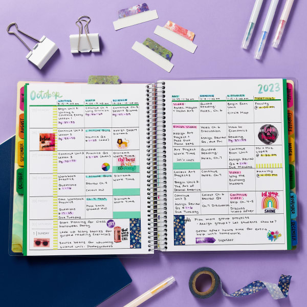 Avery and Amy Tangerine planner 29878 is open to a monthly spread for October. The planner is shown surrounded by planner accessories include Avery and Amy Tangerine Ultra Tabs 74712 which have a cool watercolor splatter design. 