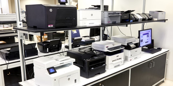 A bank of laser and inkjet printers in the Avery Research and Development lab that are used for testing printable labels