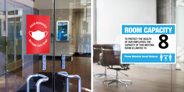 Two images side by side demonstrating common uses of COVID-19 safety signs in the workplace. One shows glass doors leading to a lobby with a red Avery Surface Safe wall decal indicating mask required beyond this point. The other shows a blue and white Avery Surface Safe wall decal on glass doors leading to a room with brown office chairs. The sign indicates that the room capacity is limited to 8 persons to maintain social distancing
