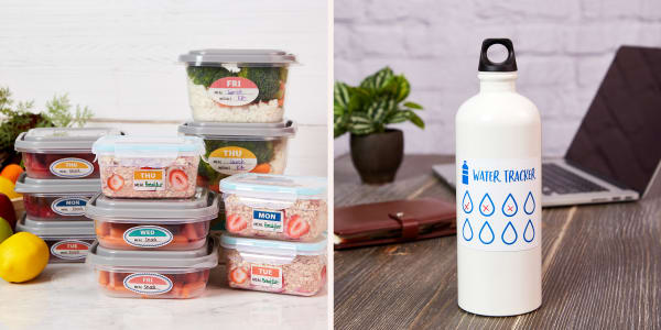 Neatly organized stacks of labeled and prepared lunches and a white water bottle with a water tracker decal sitting on a wood desk