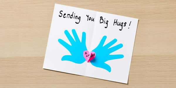 diy valentines cards example shown using blank avery greeting card with blue hand cut outs and 3d hearts with sending you big hugs written inside