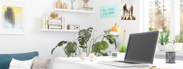 bright airy home office getting natural sunlight to help create a positive mood decor is modern clean and sophisticated and features avery printable wall decals with a motivational quote that says be a light in the dark and a family picture