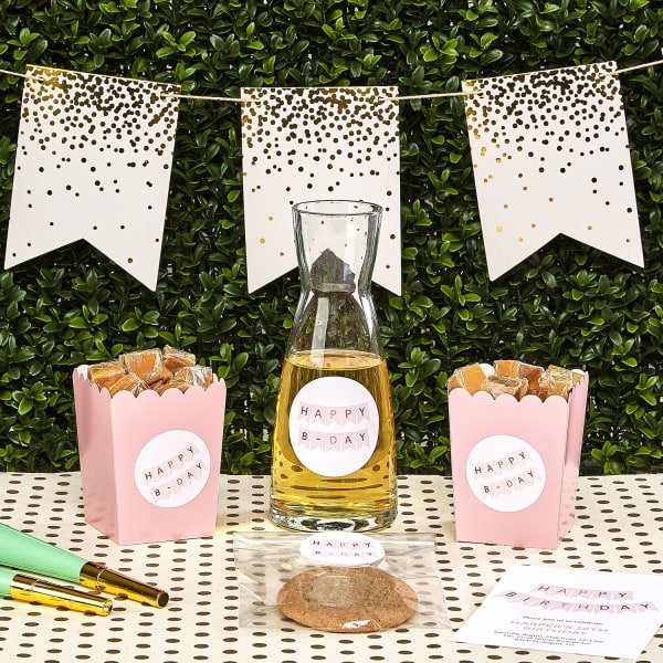 Party foods for a birthday are personalized Avery labels featuring a blush pink bunting theme. 