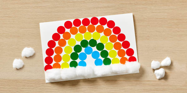 cute rainbow greeting card made with avery greeting cards color coding dotes and cotton balls shown on a light wooden table