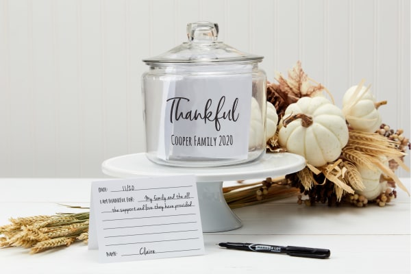beautiful white autumnal display on a white wooden table with white pumpkins and dried wheat featuring a gratitude jar made with avery labels cards and avery templates