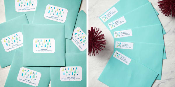 Blue envelopes labeled with customized holiday designs fanned out on a white marble surface