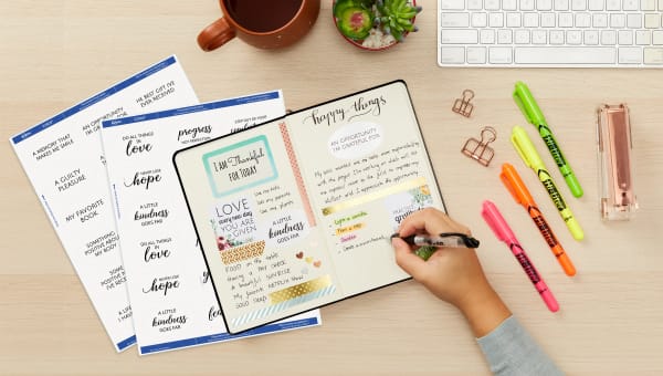Gratitude journal lovingly decorated with thoughtful sayings, cute stickers and appreciative memories surrounded with custom-printed labels and office supplies