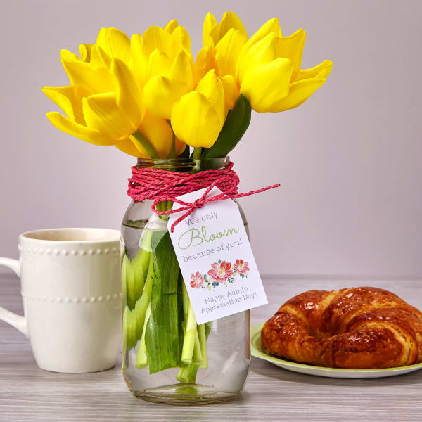 Mason jar vase with tulips croissant and coffee