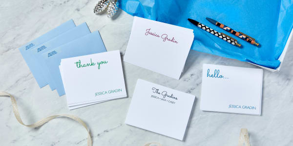 Custom-printed Avery cards and labels sitting on a marble desk ready to be packaged into a stationery set