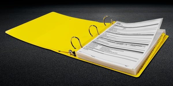 open avery heavyduty sds binder filled with safety data sheets and dividers shown on a rough gray surface