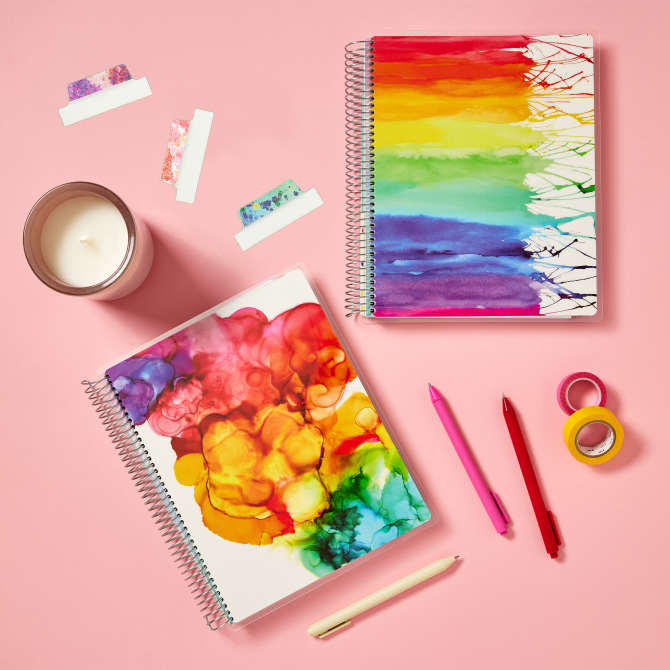 Colorful Avery + Amy Tangerine goal planners with watercolor rainbow designs on the front paint splatter Avery UltraTabs 74712.