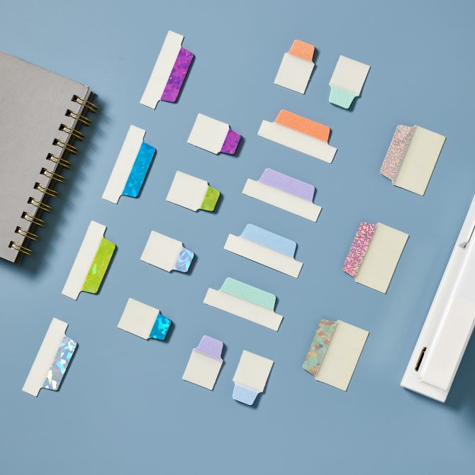 Sparkly Avery Lux Collection UtlraTabs are laid out on a blue background in in interesting, geometric pattern.