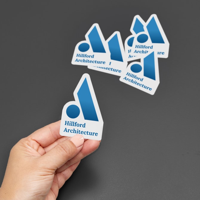 Custom printed vinyl die-cut stickers featuring a blue business logo with an interesting shape. 