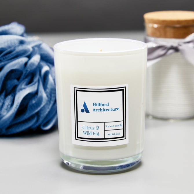 A candle and other bath products are grouped together for self-care theme. The candle features Avery waterproof label 64503 customized with branding. 