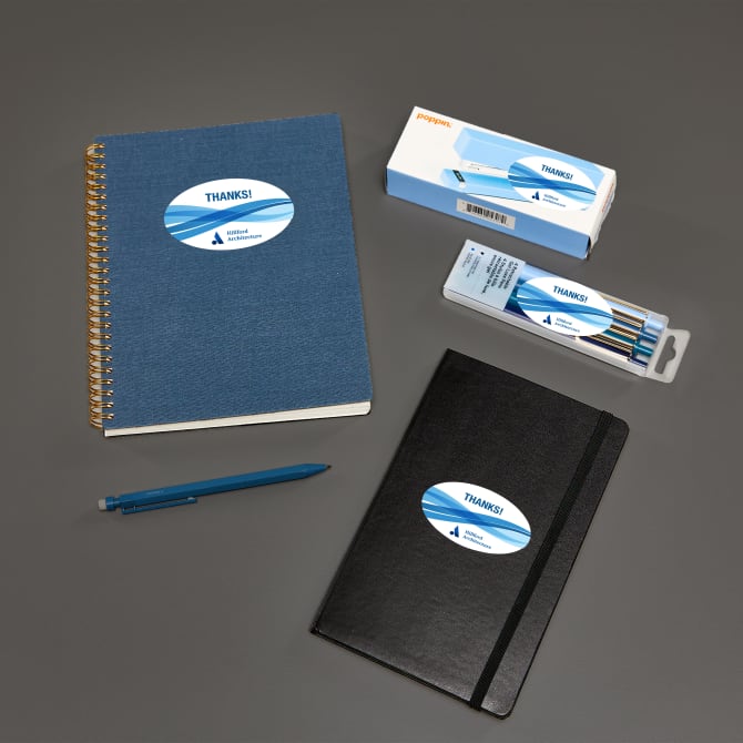 A group of notebooks and writing supplies branded with oval Avery labels 22564.