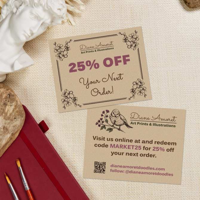 Image showing two promotional cards made with Avery templates, offering 25% off the next order. One card includes a discount code "MARKET25" with a QR code for easy online access. The cards are displayed on a light fabric surface, surrounded by art supplies, showcasing a creative farmers market promotional idea.