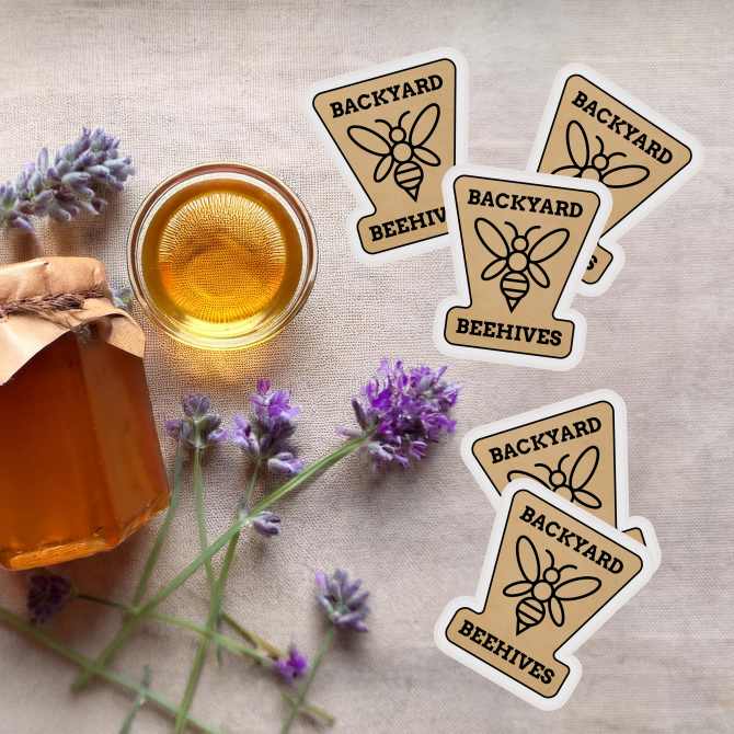 Image of honey jars, lavender sprigs, and custom Avery stickers with a "Backyard Beehives" logo, showcasing a farmers market promotional idea using branded stickers as freebies.