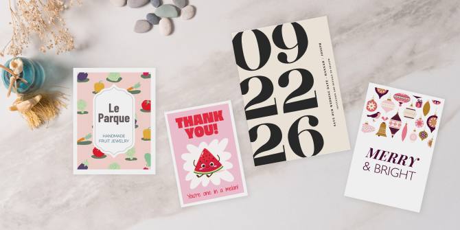 Image of four Avery postcard templates in various postcard sizes displayed on a marble surface, showcasing designs for thank-you notes, event announcements, and holiday greetings.