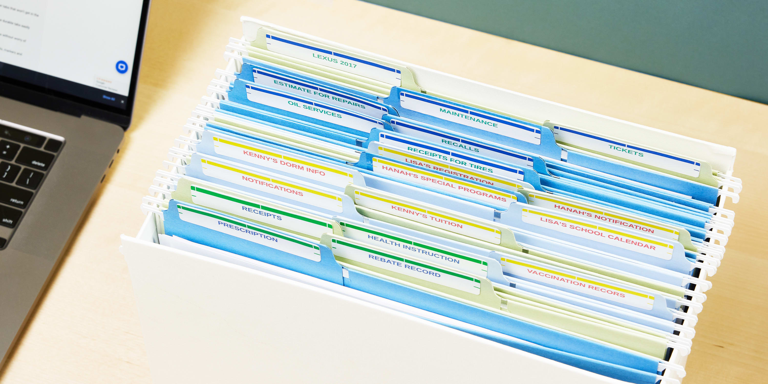 One of the best office supplies for staying organized are shown in action. Color-coded file labels are used to organize home office paperwork in a desktop file holder.