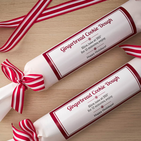cookie dough rolls wrapped in fun Christmas designs for an inexpensive gift
