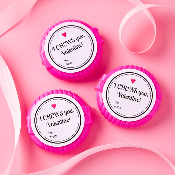 three round bubble gum containers labeled with three round 'I chews you, Valentine' labels on pink background with pink ribbon