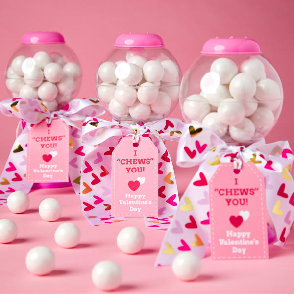 small, pink gumball machine filled with large, white gumballs and tied with adorable white bow with various colored hearts and labeled with a cute pink tag reading, 'I chews you'