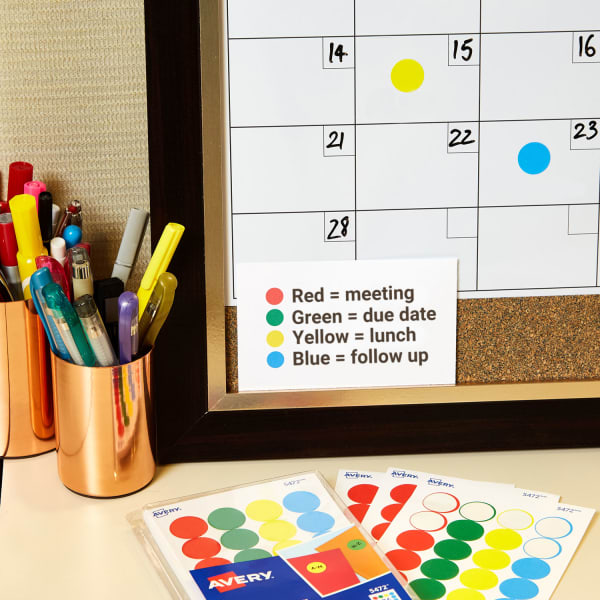 close up of organized desk supplies with white board calendar and Avery color coding labels with color code key