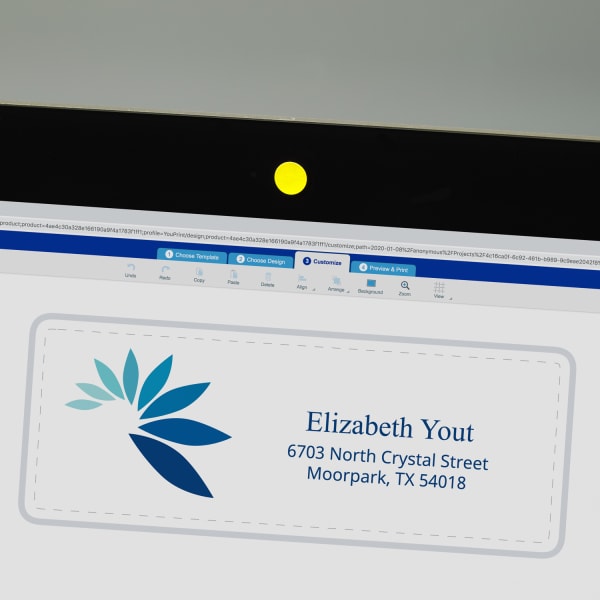 Mac computer screen webcam covered with tiny yellow dot label for privacy with Avery Design and Print Online in use on screen