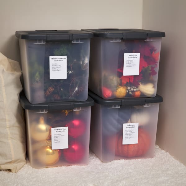 plastic bins with labels storing christmas and holiday decor is a great organization hack