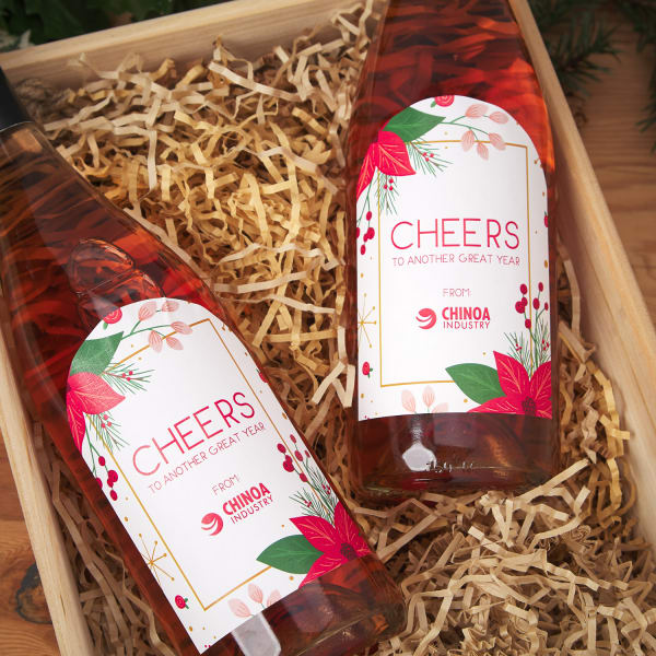 Wine bottles with custom printed labels with bright poinsettias