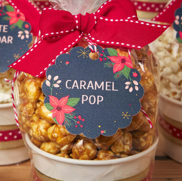 Cute bags, filled with popcorn, featuring festive poinsettia tags