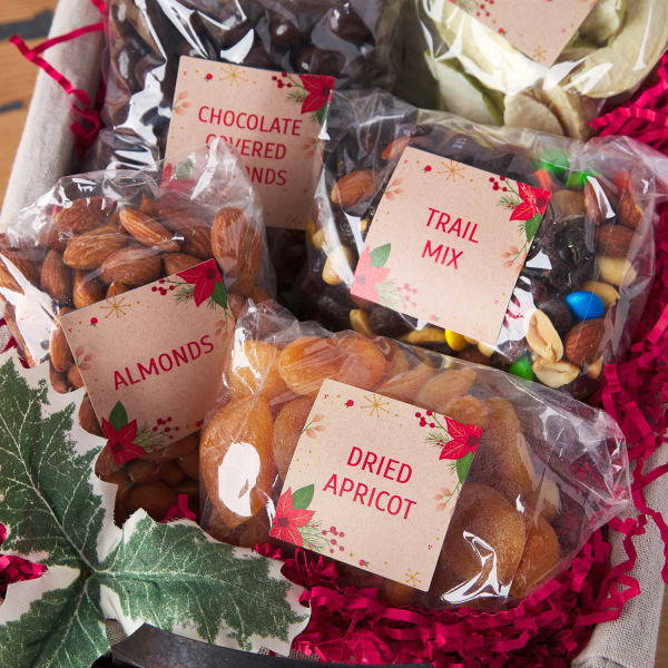 Festive basket filled with bags of dried fruits and nuts, featuring custom-printed labels