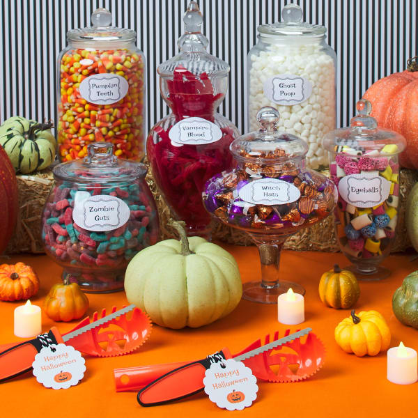 various pumpkin carving decorations, candy, and tools with festive Halloween labels and tags