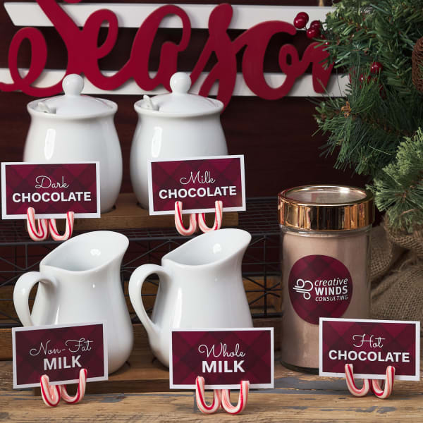 rustic chic diy hot chocolate bar signs with candy can stands dressed up with holiday greenery and festive red and white accents