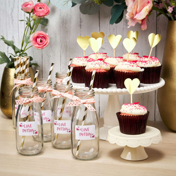 Instagram worthy galentines daydessert table adorned with cute labeled drinks and gold heart label cupcake toppers
