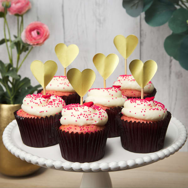 pink and white galentines day cupcakes on a white cake stand with diy heart cupcake toppers