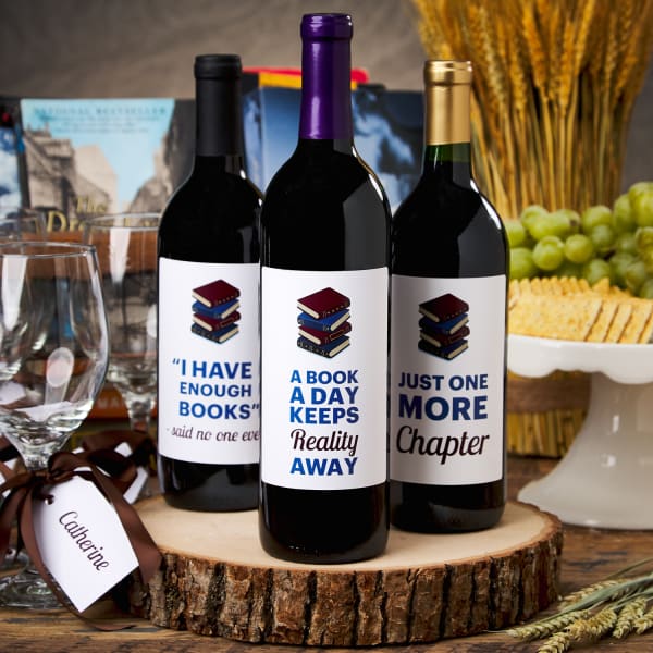 wine bottles with custom book club theme labels on wooden trunk slice