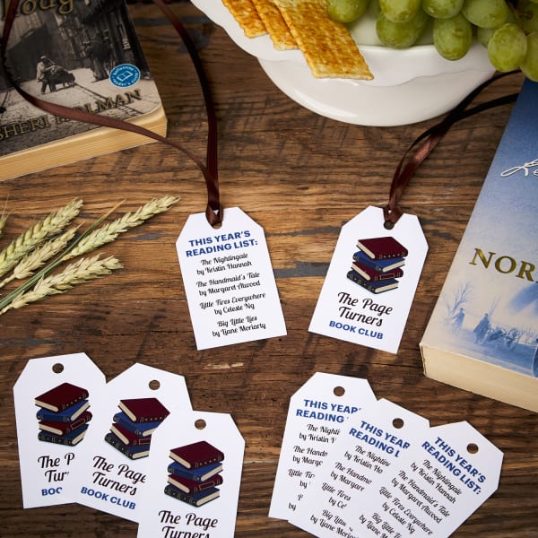 eight printable tags with book club design on table next to books and snacks