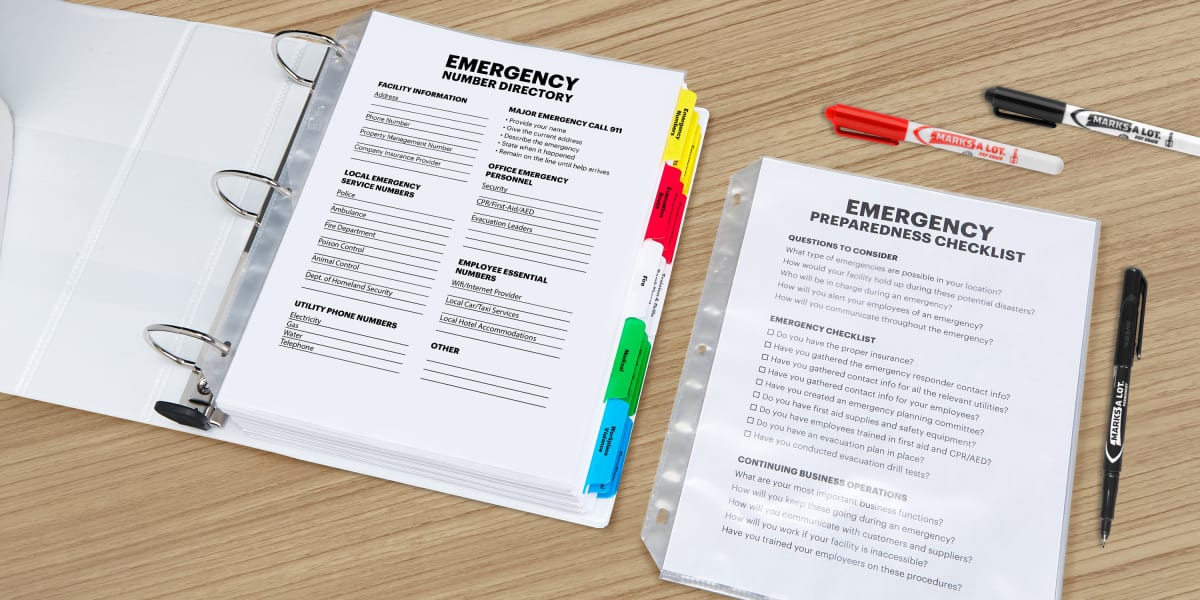 emergency binder printables made with avery templates displayed in a heavy duty binder with sheet protectors and shown on a wooden desk with avery makers