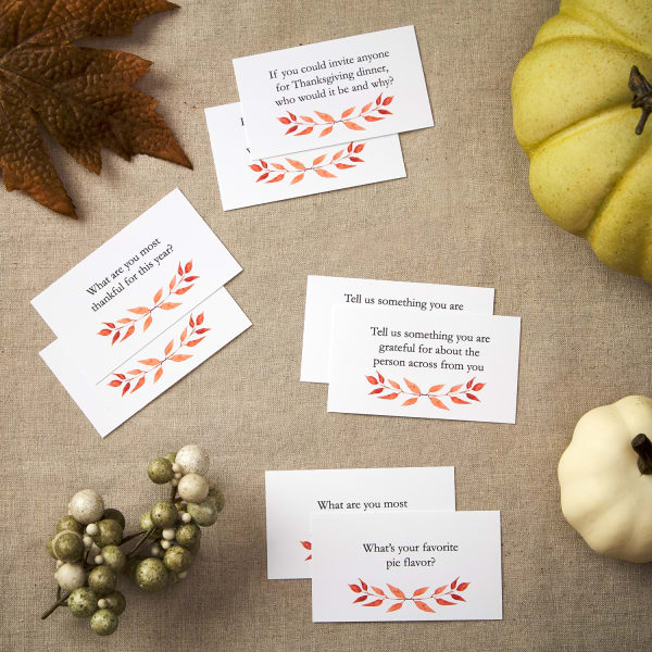 flatlay of eight Thanksgiving themed business cards on festive table