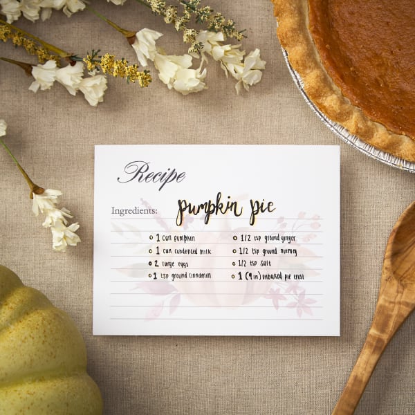 flatlay of Thanksgiving recipe card next to pumpkin pie