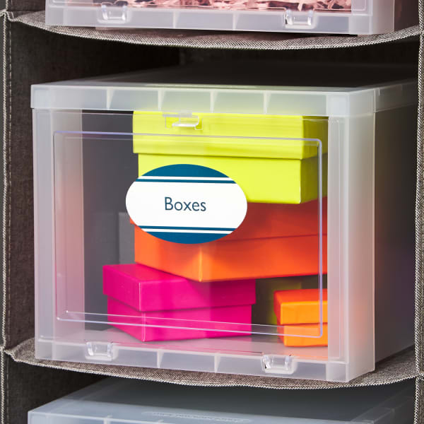 a sturdy, clear, labeled drawer in hanging fabric shelving, filled with various gift wrapping boxes in bright neon colors