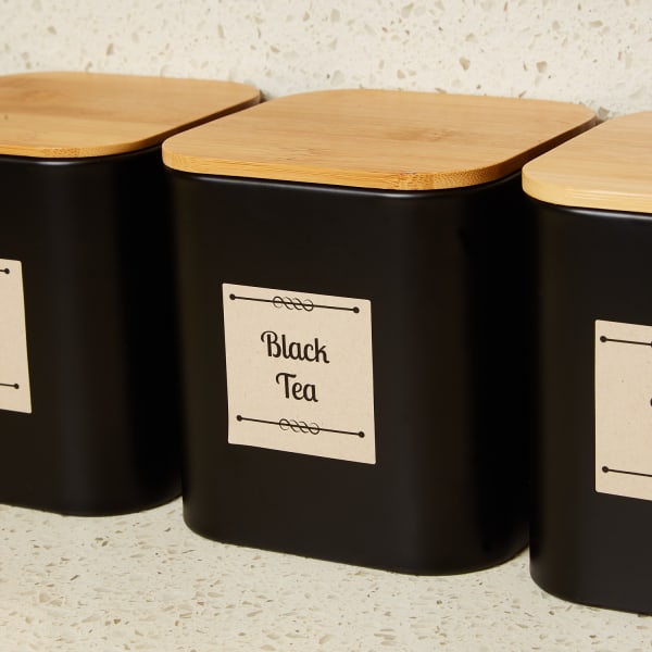 decorative counter storage for teas with natural wood lids accented with kraft paper labels