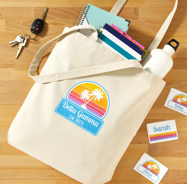 A personalized tote filled with swag. The tote is customized retro sunset design using Avery 3279 fabric transfers.
