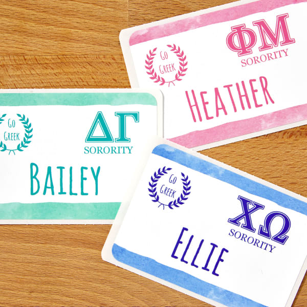 Sorority name tags made using Avery 8395 printable adhesive name badges. The designs feature Greek letters and trendy blue, mint, and pink colors.