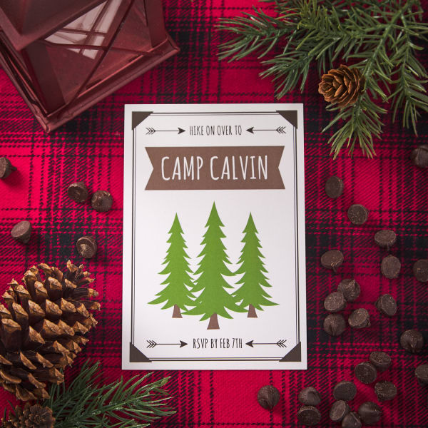 camp themed invitation on vertical postcard with pine trees on themed table