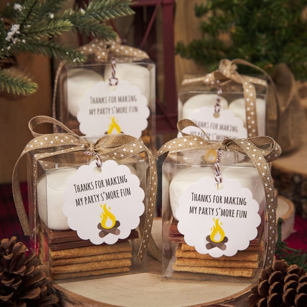 round scallop tags with log fire on party favor containers filled with s'mores ingredients like marshmallows, graham crackers, and chocolate